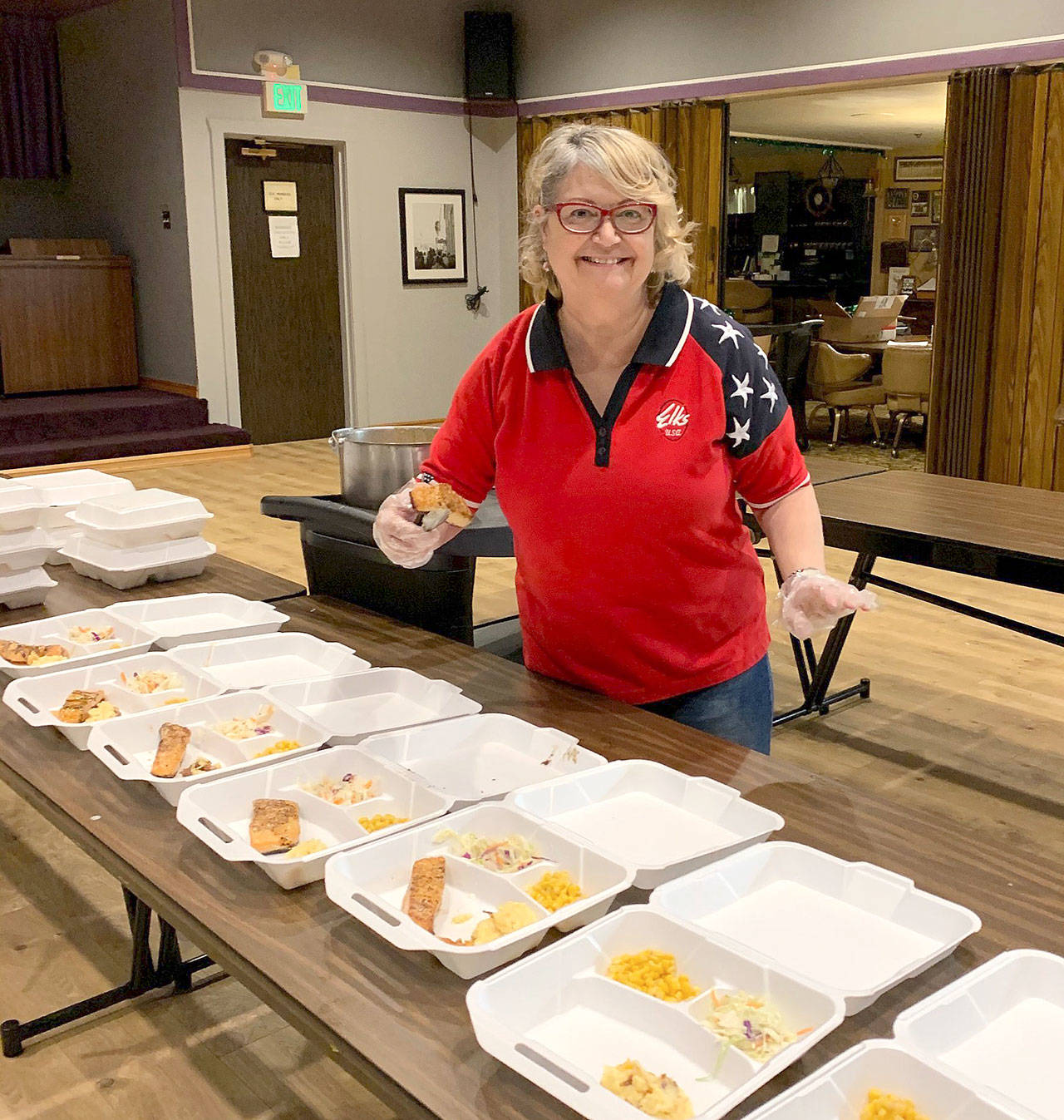 Linda Brummel serves salmon for a Friday night dinner on Easter weekend.