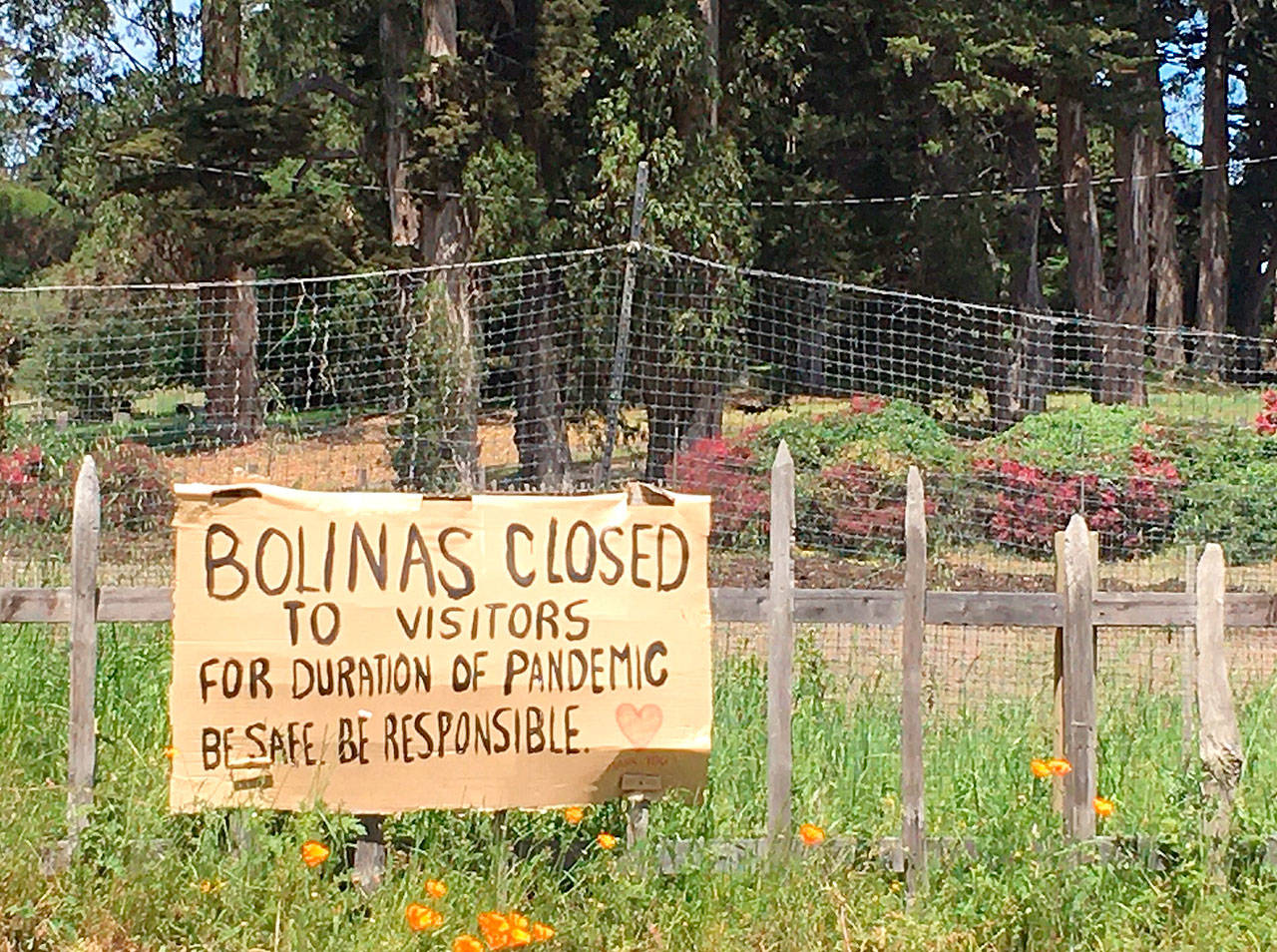 A sign hangs outside of Bolinas, California, warning visitors to stay away. (Maura Dolan/Los Angeles Times)