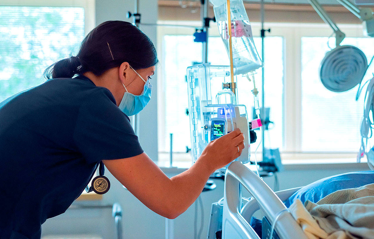 Photos by Christopher Majors Grays Harbor Community Hospital nurse Morgan Watters checks a patient’s IV.