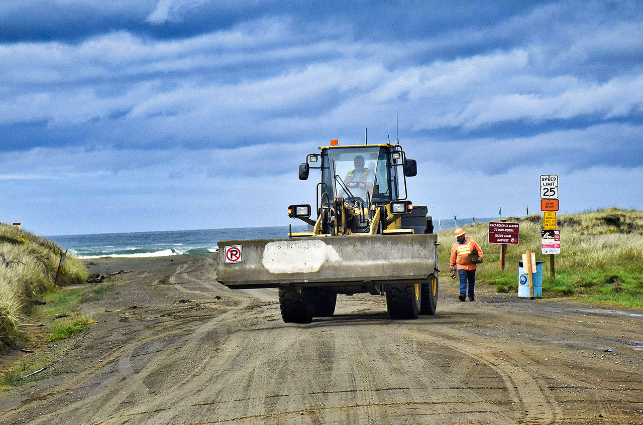 Photo by Scott D. Johnston                                 Ocean Shores City workers were out Tuesday morning removing the concrete highway barriers, including these at Chance a la Mer Blvd., that have been used to close city beach access roads to vehicles for the past seven weeks.