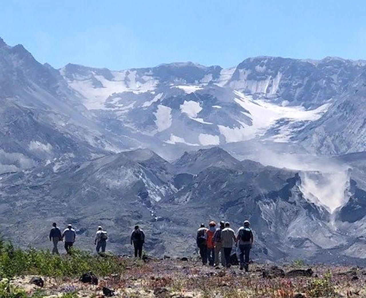 The Mt. St. Helens crater towers above hikers on a trail crossing the Pumice Plain, where the U.S. Forest Service proposes a controversial road. (U.S. Forest Service)