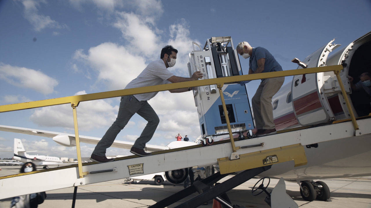 Elliot and Arthur Kreitenberg push the GermFalcon on a plane to disinfect the cabin. (George Sayah/Lunch Break Productions)