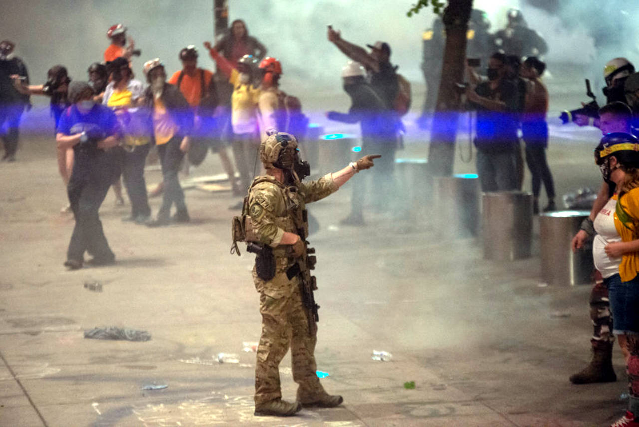 A federal officer points to a protester while clearing the street in front of the Mark O. Hatfield U.S. Courthouse on July 20, 2020 in Portland, Oregon. (Photo by Nathan Howard/Getty Images/TNS)