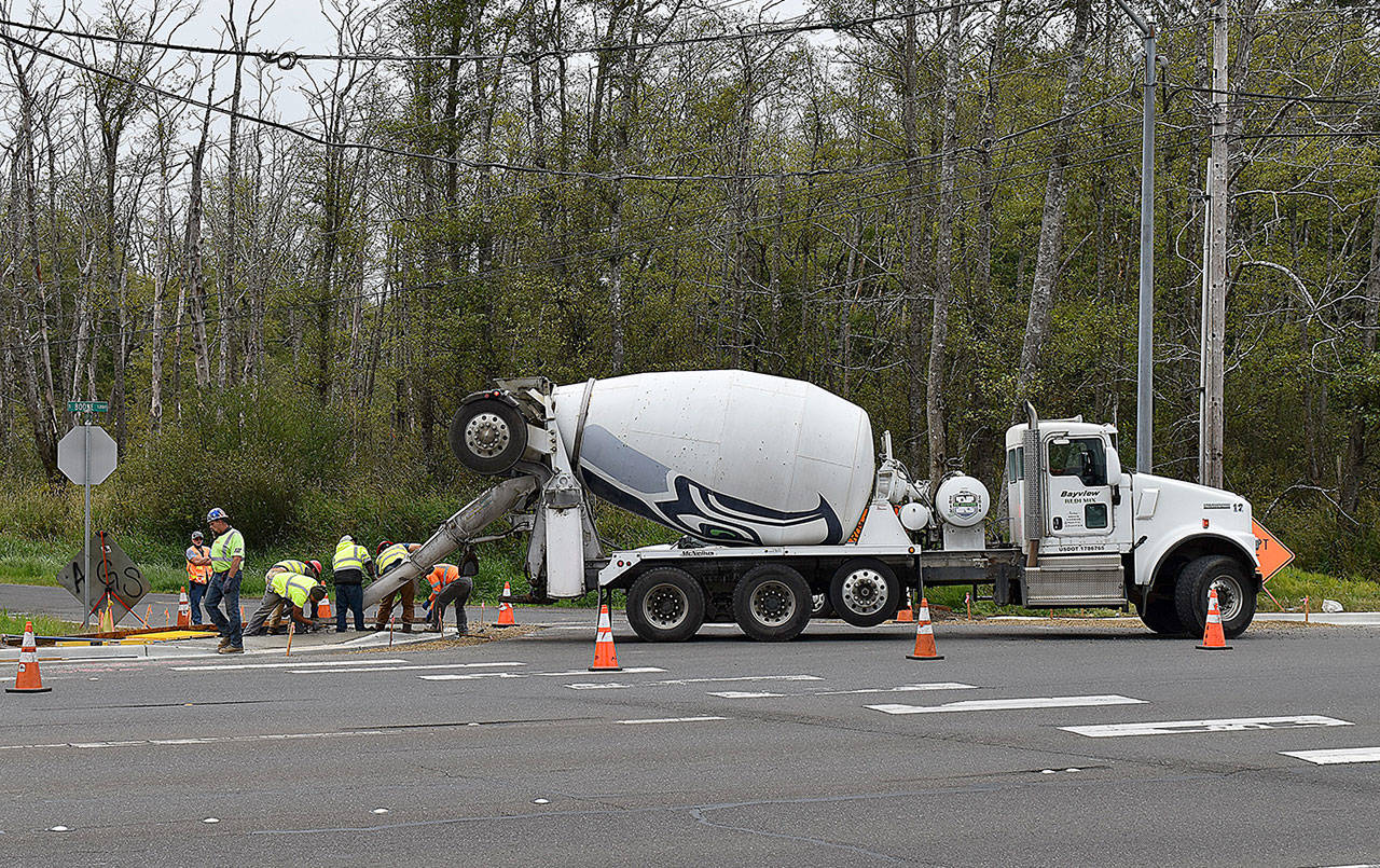 DAN HAMMOCK | GRAYS HARBOR NEWS GROUP                                 Crews from Ronglin’s Inc. pour an ADA sidewalk ramp at the corner of South Boone and West Huntley streets in south Aberdeen Friday, part of the city’s Grays Harbor College Neighborhood Connection project.