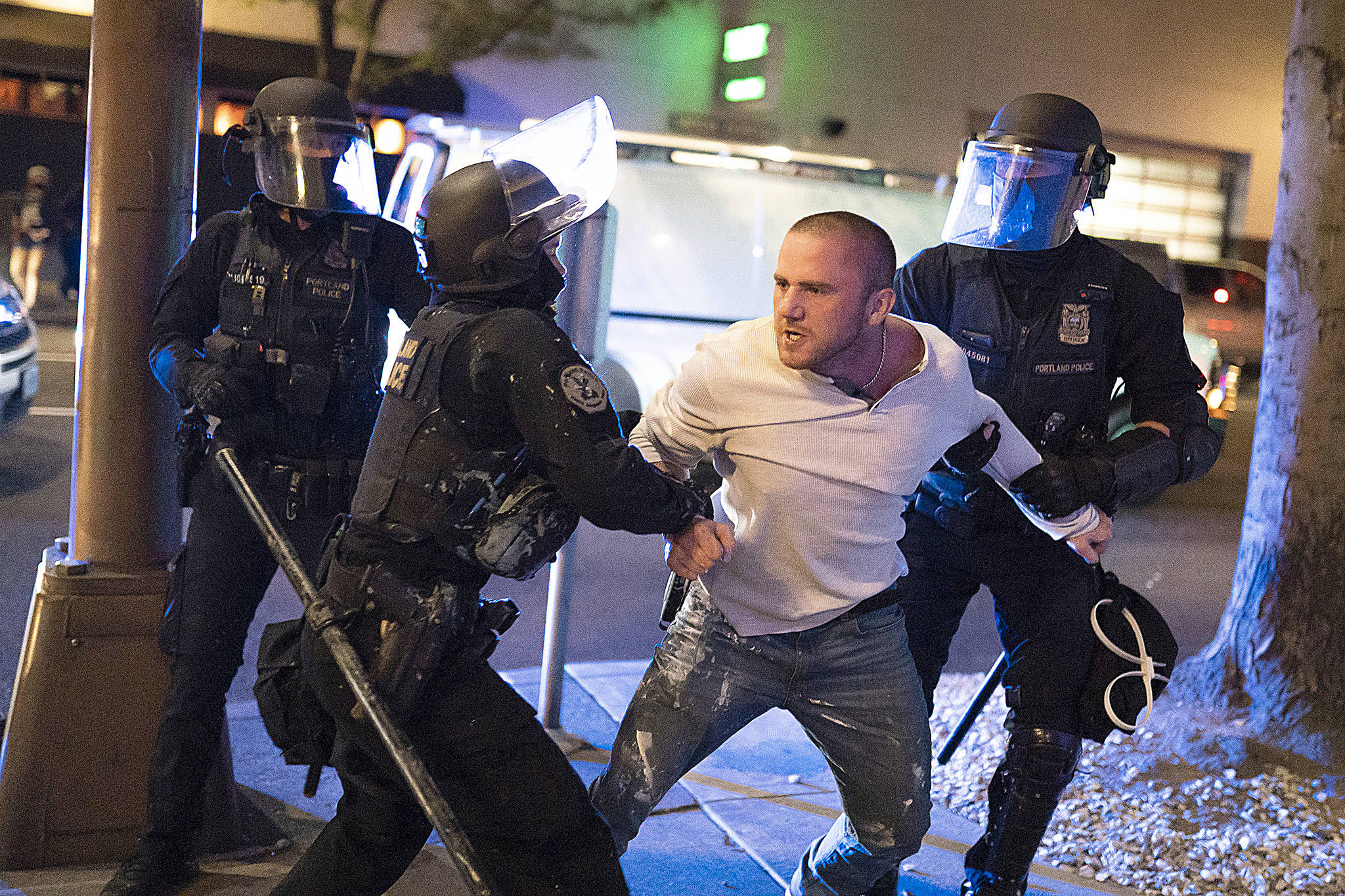 Nathan Howard/Getty Images/TNS                                 Portland police hold back Chandler Pappas, who was with the victim of a fatal shooting as he reacts in the minutes after the incident on Saturday, August 29, 2020 in Portland, Oregon. Far left counter-protesters and pro-Trump supporters clashed Saturday afternoon as a parade of cars carrying right wing supporters made their way from nearby Clackamas to Portland.