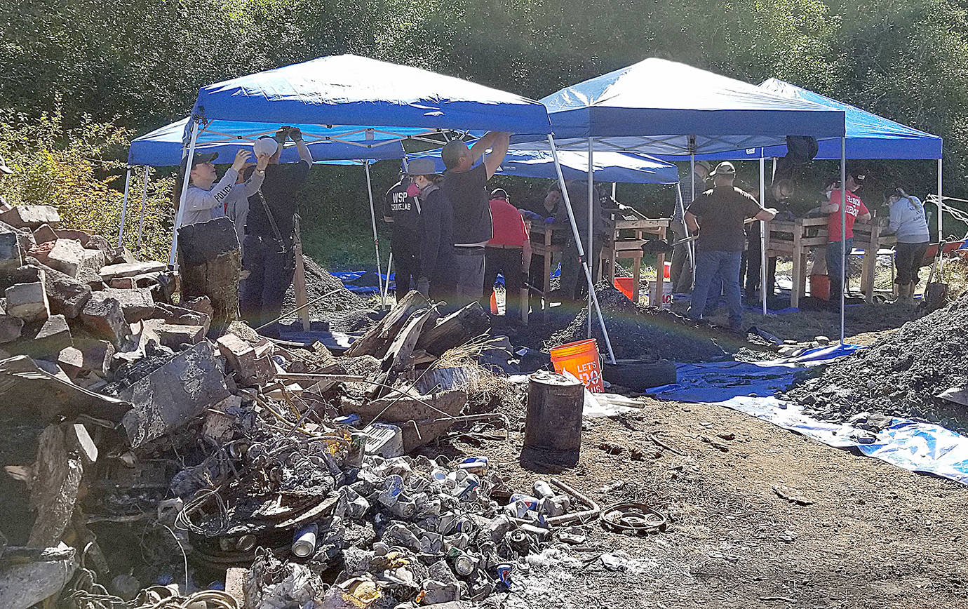 COURTESY MASON COUNTY SHERIFFS OFFICE                                Investigators set up canopies as they search for evidence.