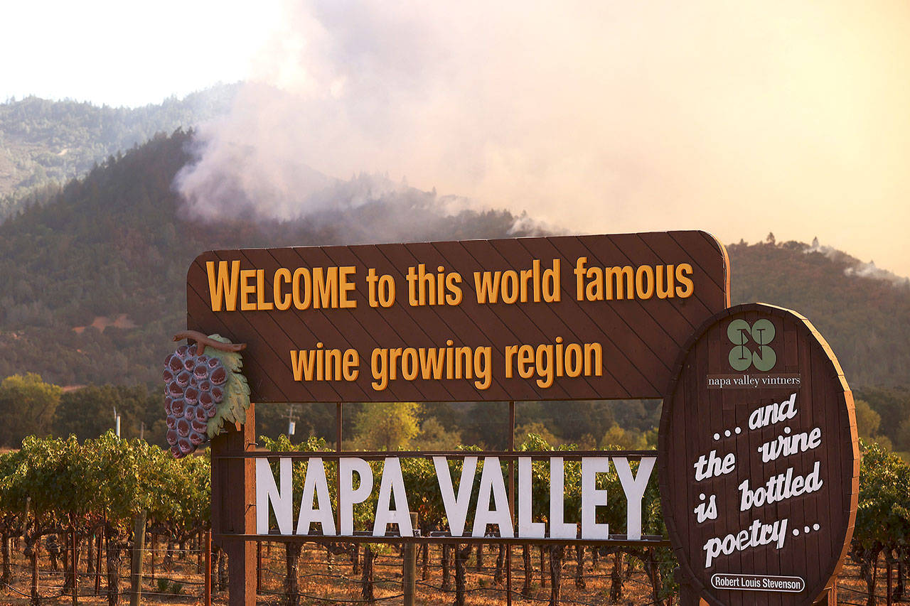 Smoke from the Glass Fire rises from the hills Sunday in Napa, California. The fast moving blaze has burned more than 11,000 acres and has destroyed homes. Much of Northern California is again under a red flag warning for high fire danger. (Justin Sullivan/Getty Images)