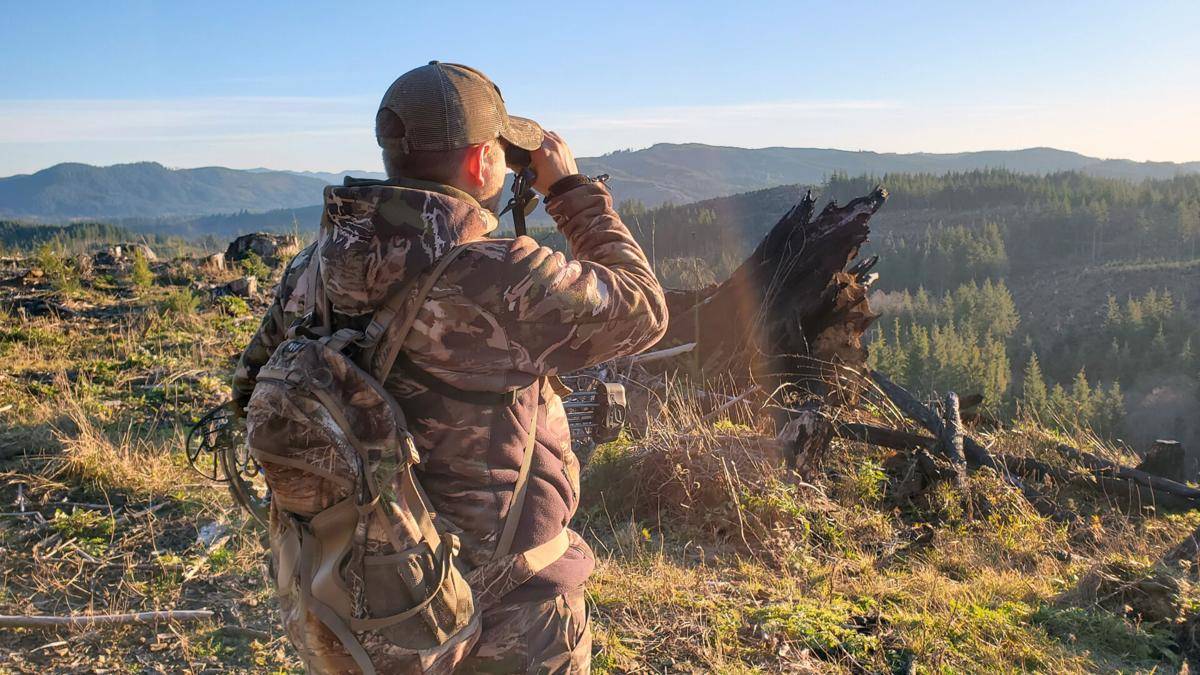 Jeff Boggs surveys a clearing with binoculars during an elk hunt on Dec. 4.