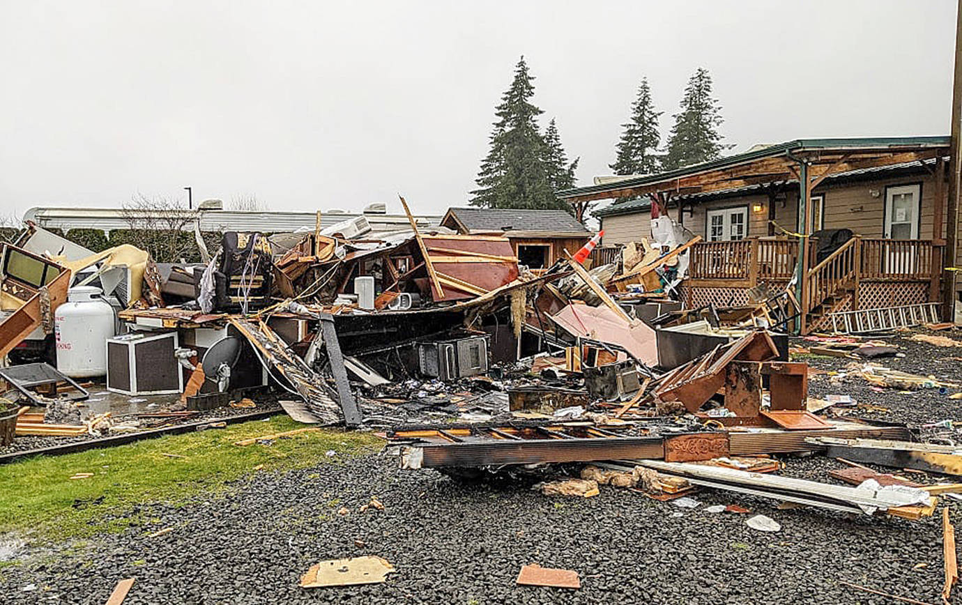 REA HOLCOMB PHOTO 
A pile of rubble is all that remains of a residence in the Travel Inn RV Resort in Elma. Two people suffered burns in an explosion and fire at the residence Saturday and were transported to Harborview Medical Center in Seattle for treatment.