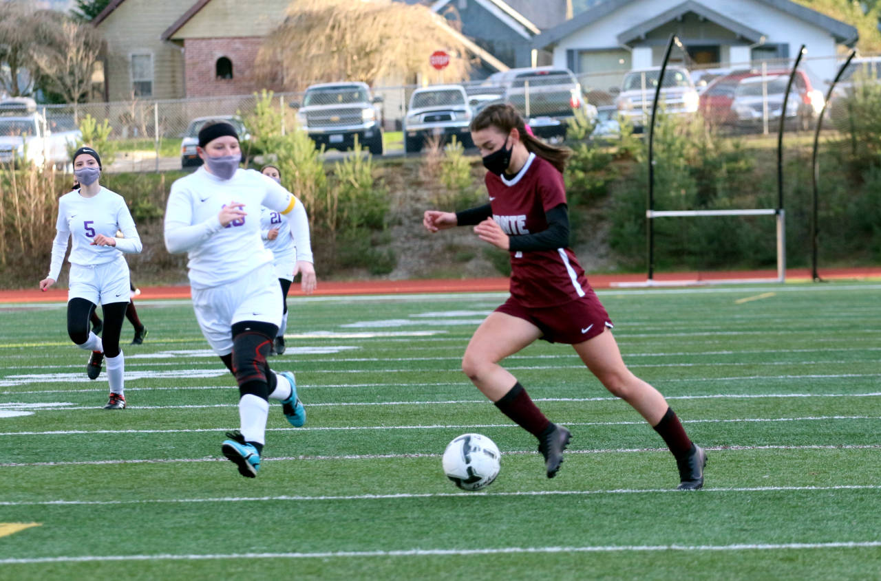 Montesano forward Jaiden Morrison, right, drives to the goal while being pursued by Goldendale’s Danae Dunlap during the Bulldogs’ 9-0 win in the first round of the 1A District 4 Tournament on Monday in Montesano. (Ryan Sparks | The Daily World)