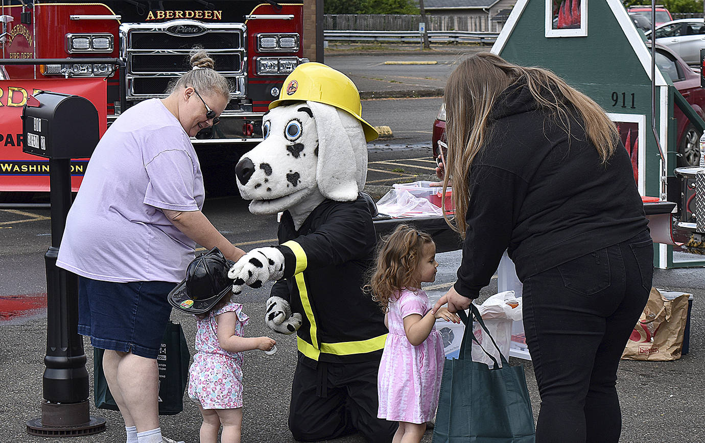 DAN HAMMOCK | THE DAILY WORLD 
Sparky the Fire Dog handed out helmets to kids at the emergency preparedness expo in South Aberdeen Saturday.