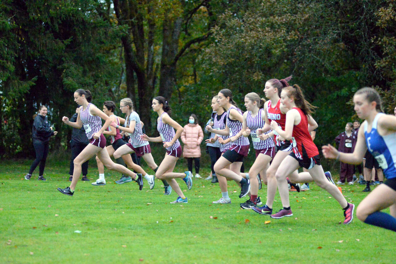 RYAN SPARKS | THE DAILY WORLD Montesano’s Lilly Schweppe, left, leads the field off the starting line of the 1A Evergreen League cross country championship meet on Thursday at Oaksridge Golf Course in Elma.