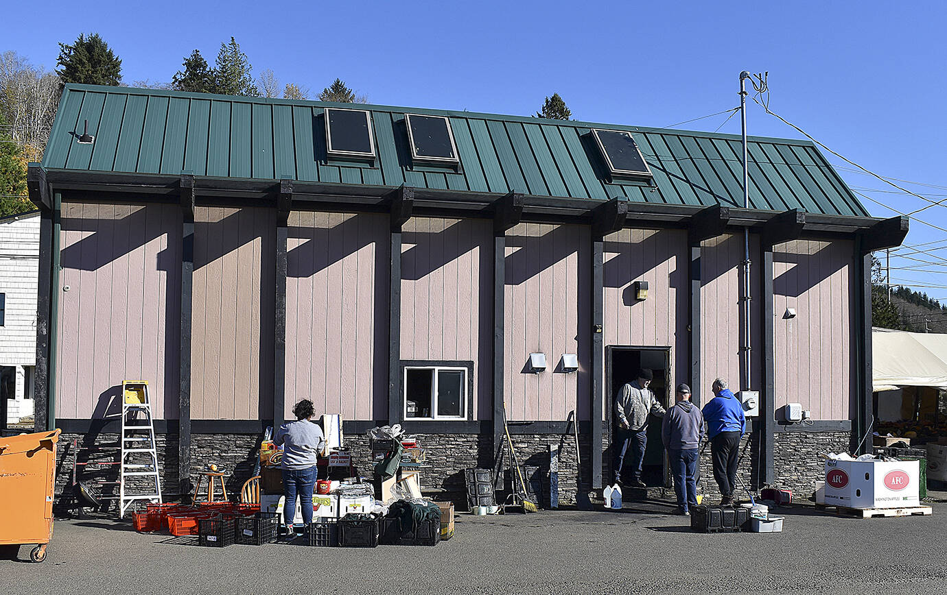 DAN HAMMOCK | THE DAILY WORLD 
Franko’s Farmstand staff clean up after a fire Saturday morning. The farm stand was closed Saturday but able to reopen for regular hours Sunday.