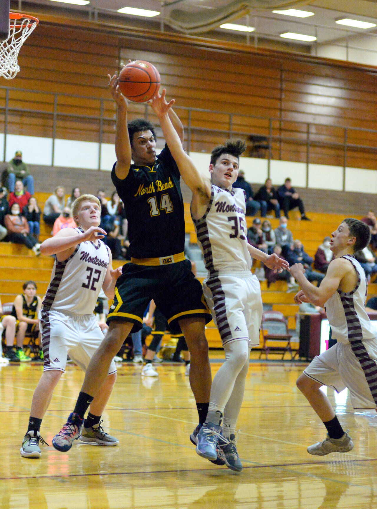 RYAN SPARKS | THE DAILY WORLD North Beach’s Tre’Vaughn Greene (14) and Montesano’s Caydon Lovell (35) compete for a rebound during the Hyaks 46-34 victory on Wednesday at Bo Griffith Memorial Gymnasium in Montesano.