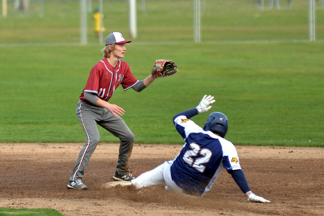 RYAN SPARKS | THE DAILY WORLD Aberdeen’s Trevon Nichols (22) slides into second base with a run-scoring double in front of Hoquiam shortstop Zander Jump (11) during the Bobcats’ 20-1 win over Hoquiam on Wednesday at Olympic Stadium in Hoquiam.