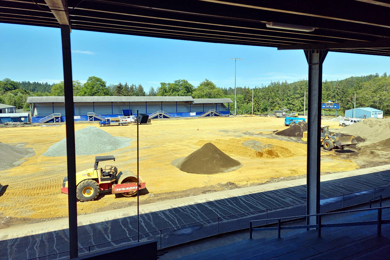 RYAN SPARKS | THE DAILY WORLD Construction crews work on completing the turf at Stewart Field on Wednesday, July 27. An earlier permit-related delay pushed back the projected completion date until after the start of the fall sports prep season, causing the loss of home games for Aberdeen High School’s football and girls soccer teams.