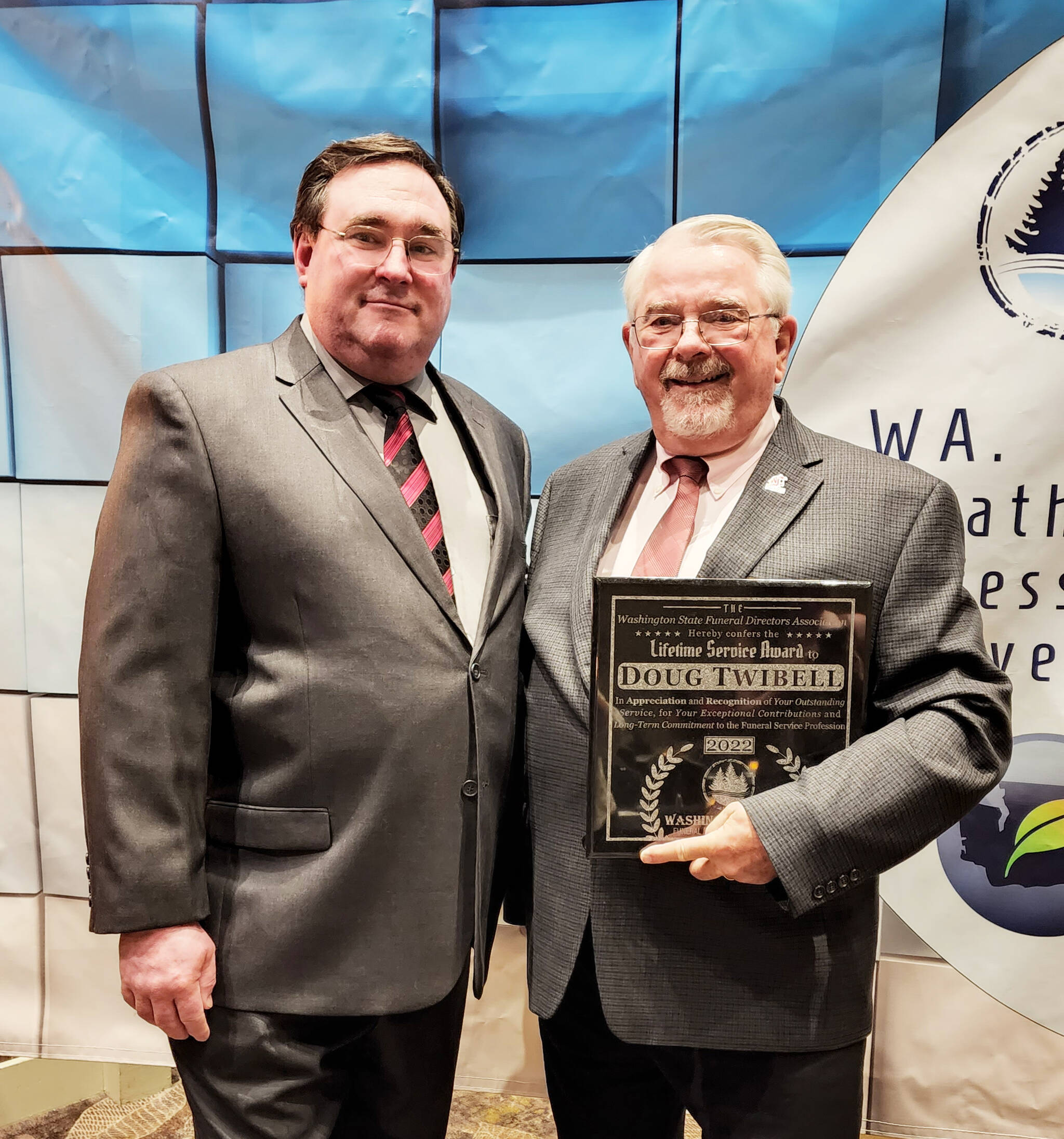 Doug Twibell, right, former owner of Twibell's Fern Hill Funeral Home in Aberdeen, recently received the Washington State Funeral Directors Association Lifetime Service Award. Son Keith, left, and his wife Heather, are the current owners of the funeral home. Courtesy photo