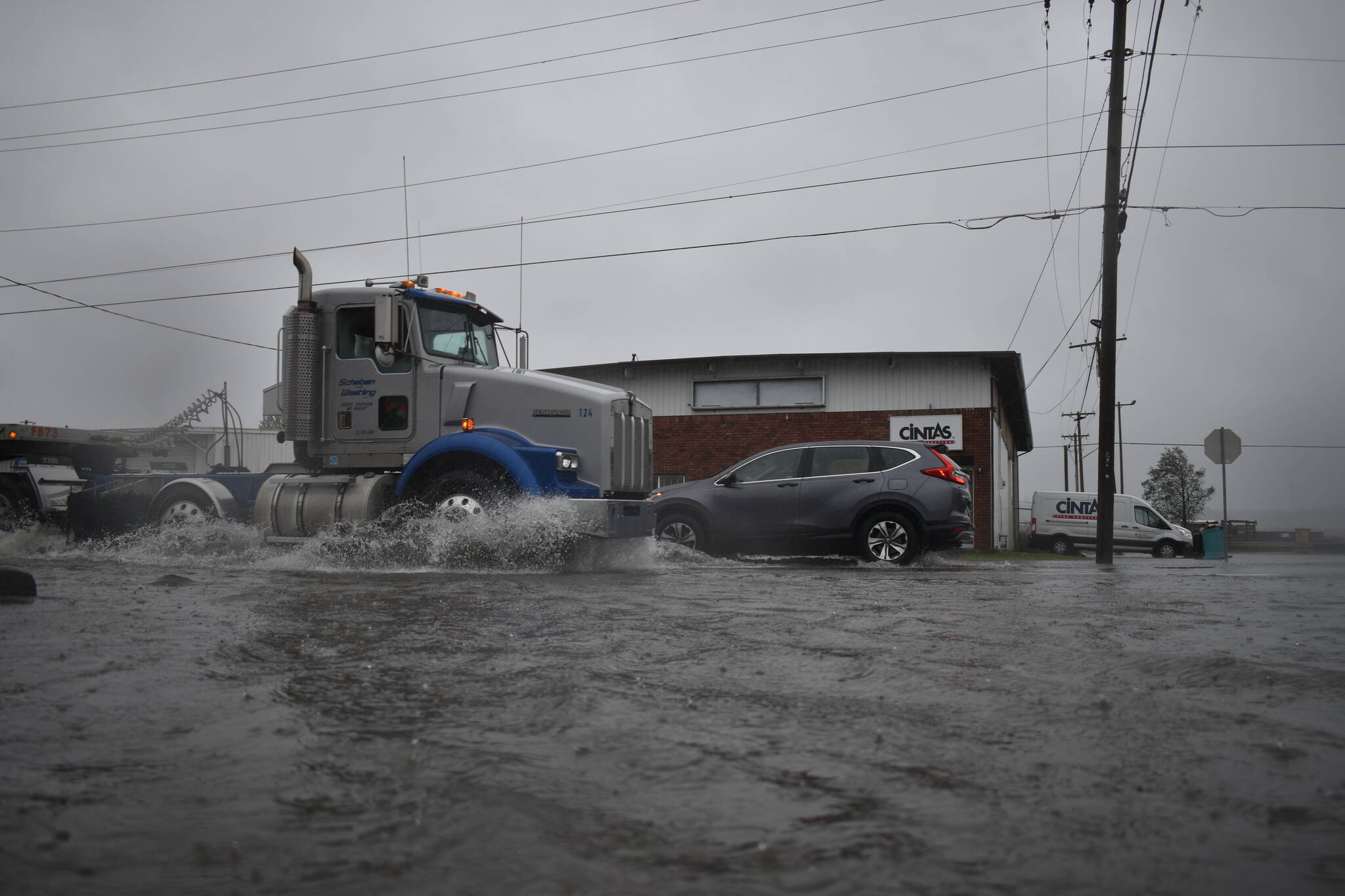 Stormwater filled streets Friday afternoon with several inches of water in some places, slowing traffic. (Clayton Franke / The Daily World)