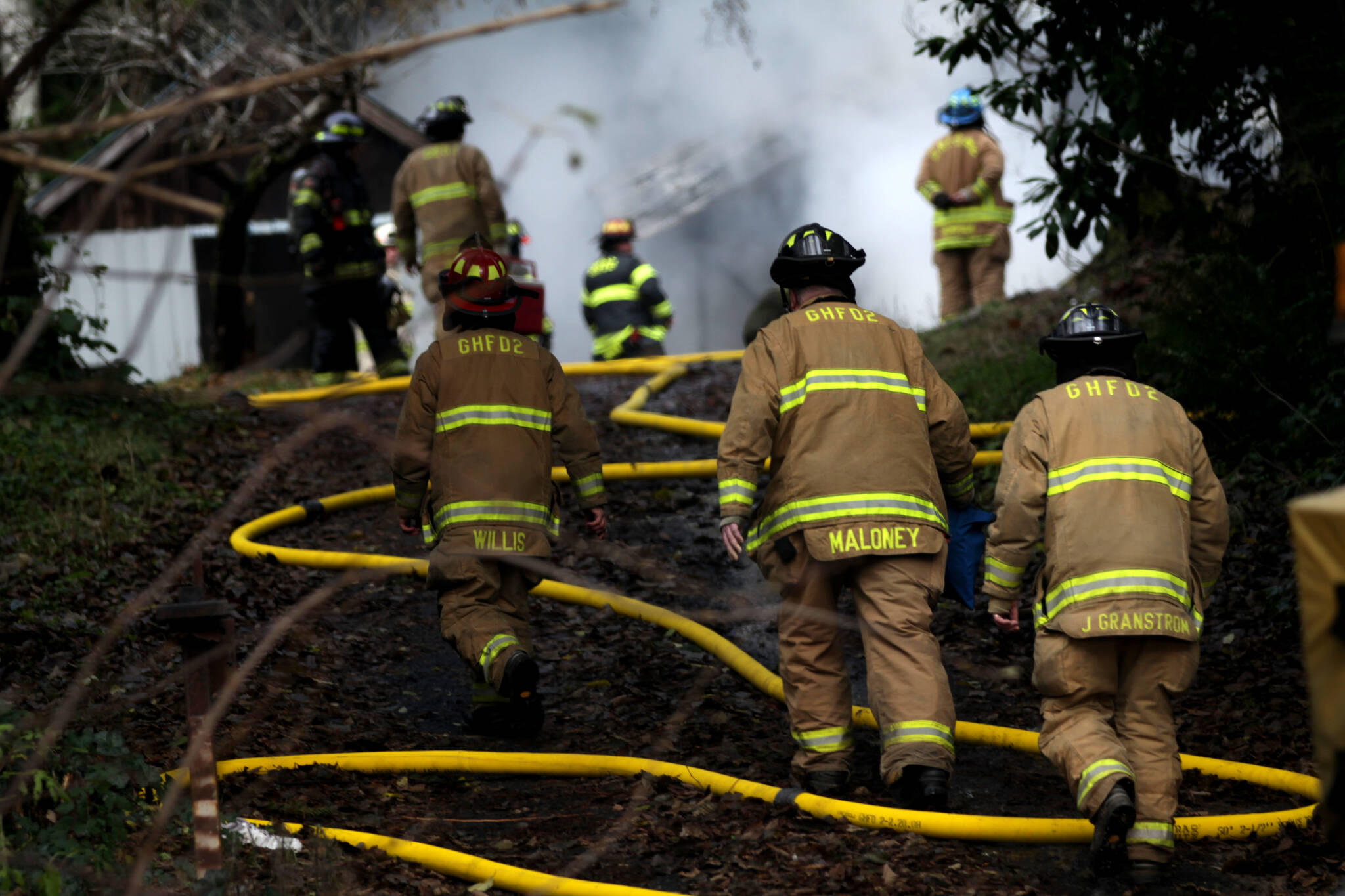 Firefighters climb toward a structure fire that broke out on Dec. 13 outside of Aberdeen. (Michael S. Lockett / The Daily World)