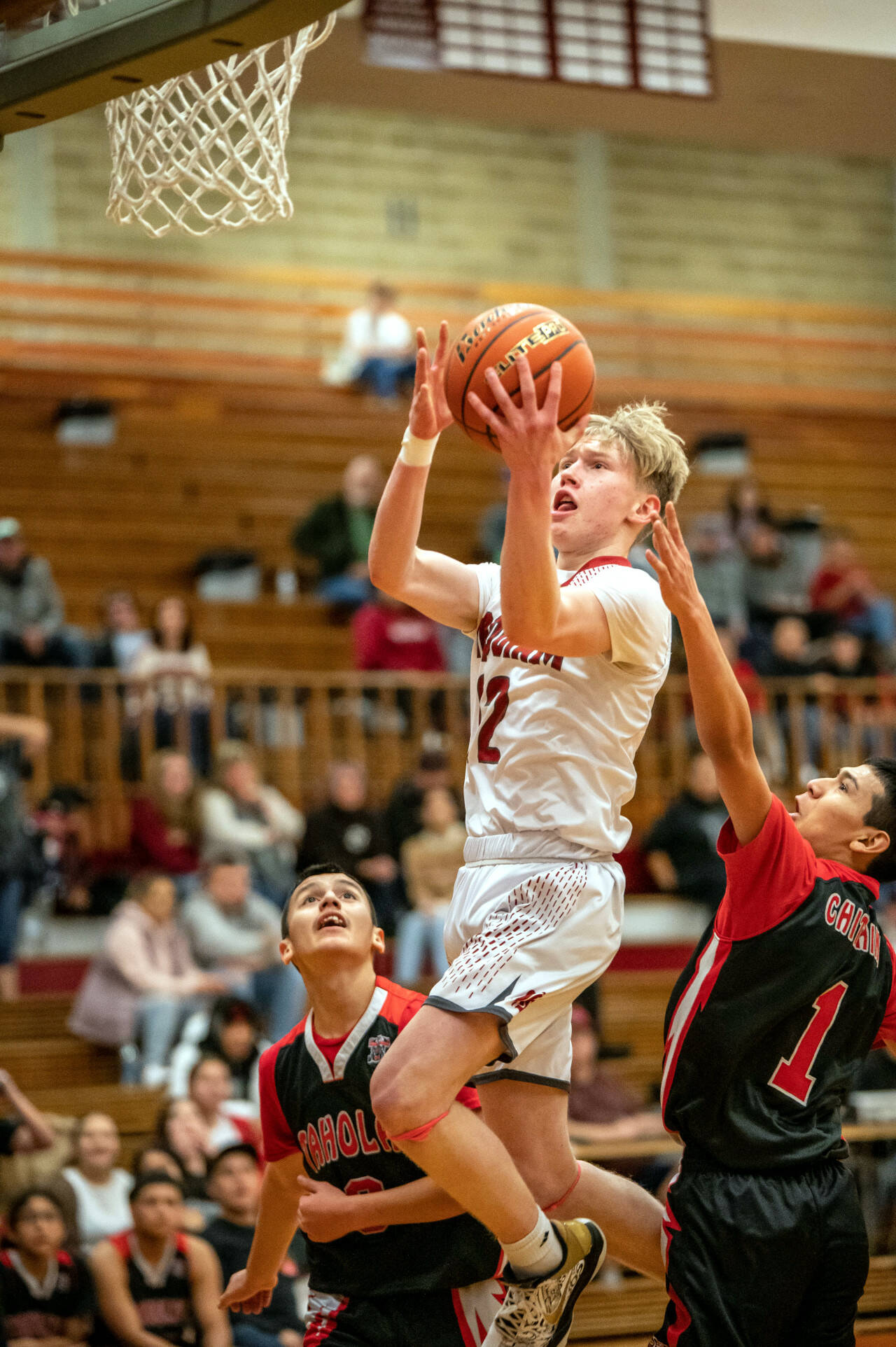 PHOTO BY FOREST WORGUM Hoquiam senior Michael Lorton Watkins (12) glides to the basket during the Grizzlies’ 83-31 win over Taholah on Thursday at Hoquiam Square Garden.