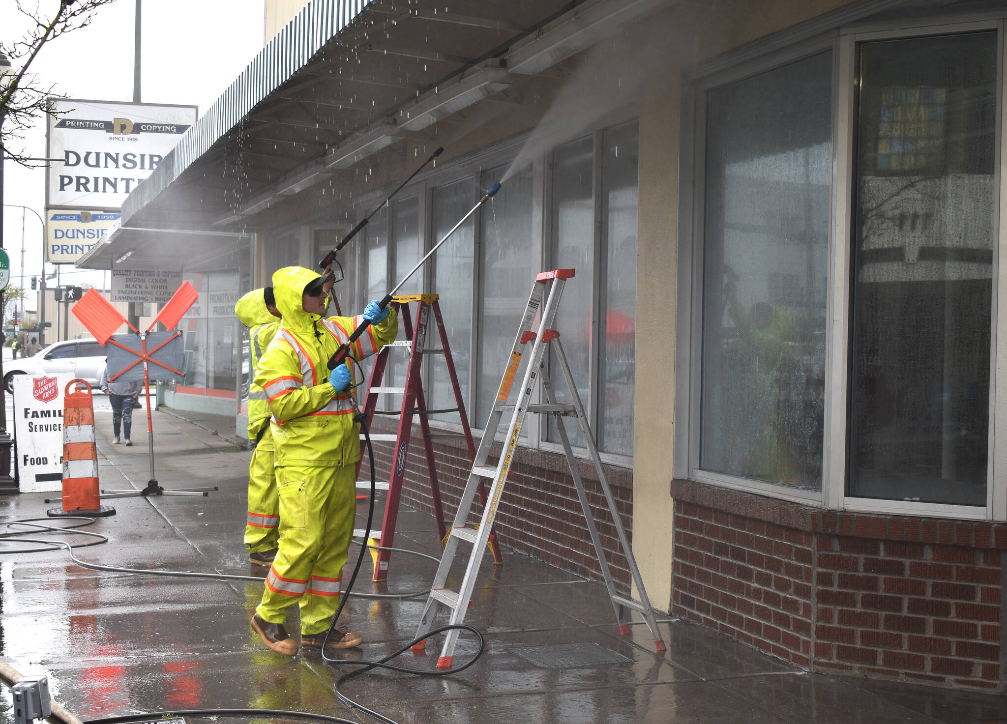 Matthew N. Wells / The Daily World
Sean McAllister and Max Acosta, public works employees for the city of Aberdeen, pressure wash the outside of 118 W. Wishkah St., the future home of the Aberdeen Museum of History. Staff also removed the old Salvation Army sign that hanged above the awning.