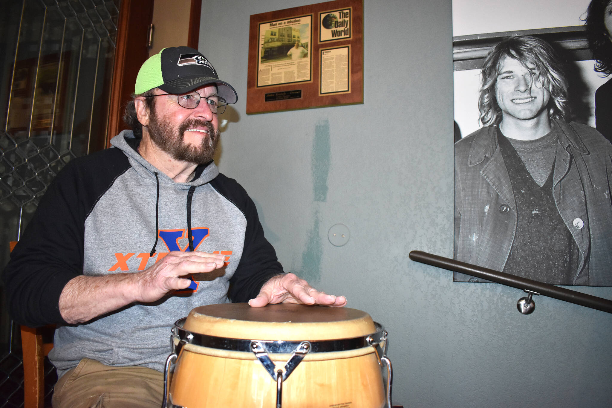 Doug Paling, a local musician who has played up and down the West Coast, accompanied Wil Russoul on the conga. Russoul, executive director of Downtown Aberdeen Association, played on an acoustic guitar signed by many names, including Aaron Burckhard, the original drummer for Nirvana. The pair played in front of a Darrell Westmoreland photograph of Kurt Cobain, Dave Grohl and Krist Novoselic that hangs inside Nirvana Coffee Company.