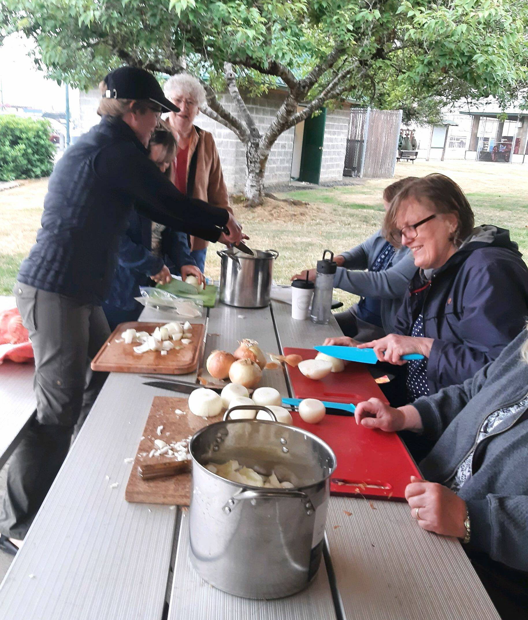 Donna Michalak, rear, heads an onion-chopping table Friday morning in preparation for the 64th annual McCleary Bear Festival. Volunteers chopped 150 pounds of onions for the stew. (Courtesy of Sue Michalak-Budsberg)