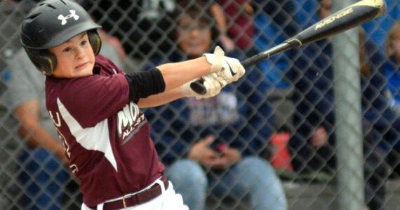 RYAN SPARKS | THE DAILY WORLD Montesano’s Kale Kjesbu smacks a single during an 8-5 loss to Larch Mountain in the Little League District 3 Majors Tournament on Friday in Aberdeen.