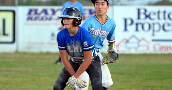 RYAN SPARKS | THE DAILY WORLD
Elma's Brysten Crawford, foreground, leads off second base as Bellevue National shortstop Ryota Suzuki keeps a close eye during Elma's 14-0 loss at the Little League Intermediate State Tournament on Thursday in Elma.