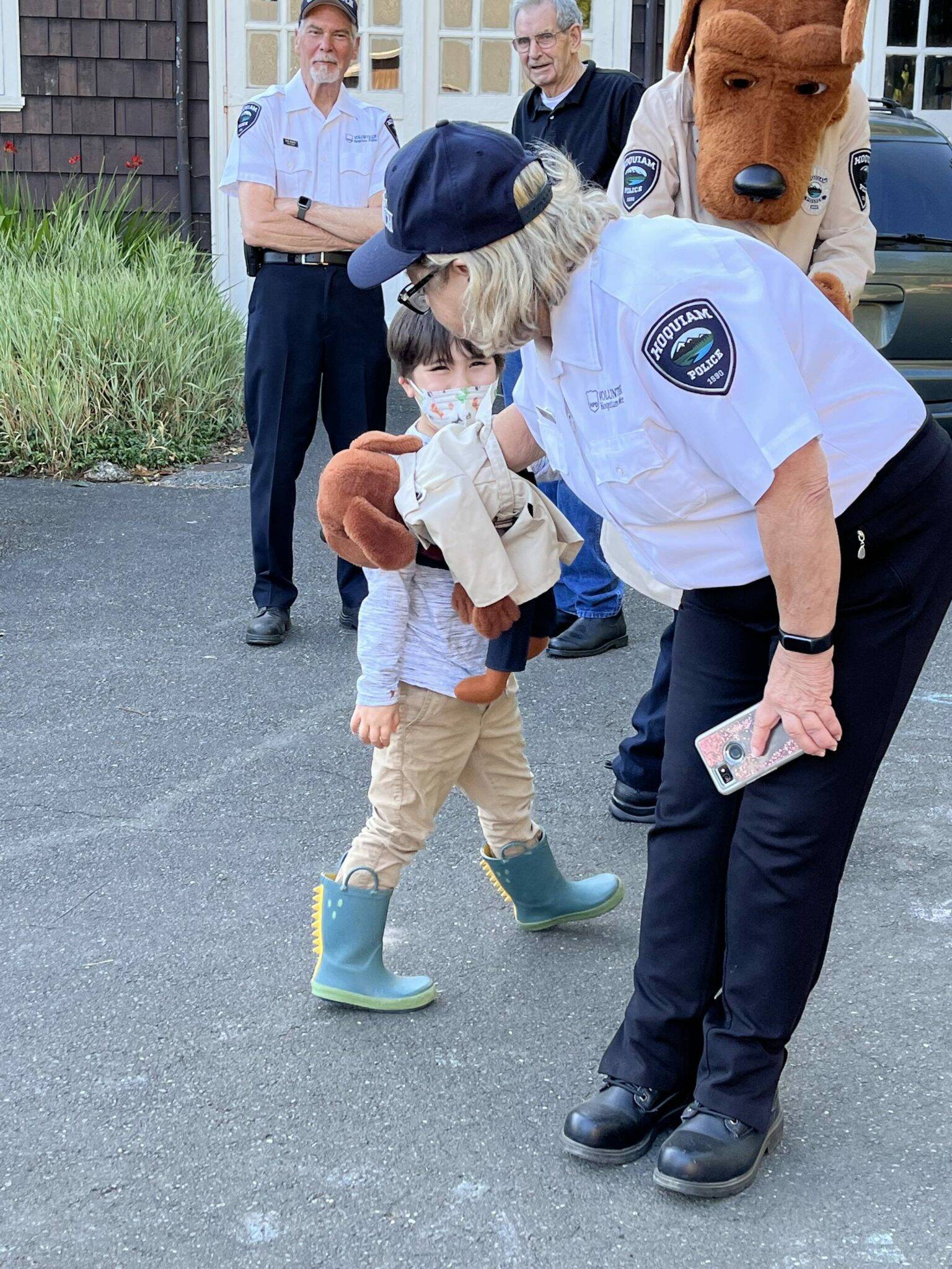 Betsy Seidel, Hoquiam Police Crime Watch coordinator, has McGruff the Crime Dog Jr., give a kiss to one of the many children at National Night Out on Tuesday, Aug. 2, 2022, at Polson Museum. (Matthew N. Wells | The Daily World File)