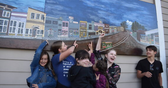 Matthew N. Wells / The Daily World
A small group who helped create a “diptych” — merging two panels into one seamless one — point to portions of their artistic contributions. From left, Maddie and Abbi Cihak, Gabby Schreck, Ellie Cihak, Chloe Long and Jackson Cihak, were all smiles Tuesday evening after the hanging of the two panels. The panels show prominent buildings from parts of Cosmopolis’ early history.