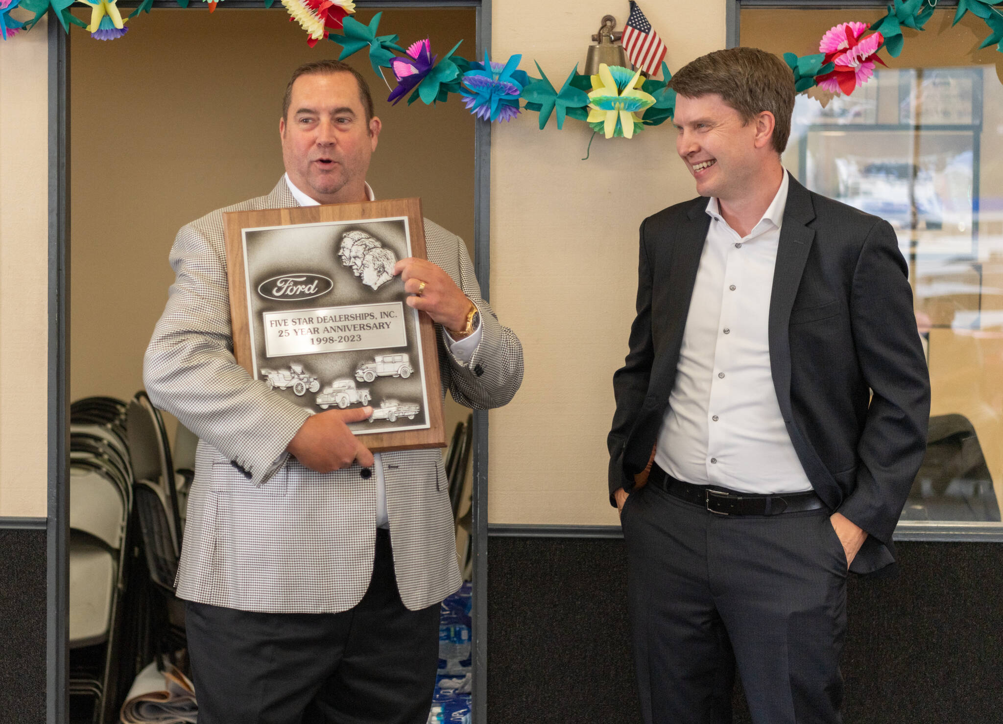 Rich Hartman, left Five Star dealerships owner holds a 25-year anniversary plaque, accompanied by Ford Regional Manager Steven Kettler, during a celebration on Monday, Aug. 28 at the dealership's east Aberdeen location. (Alicia Tisdale / Five Star Dealerships)