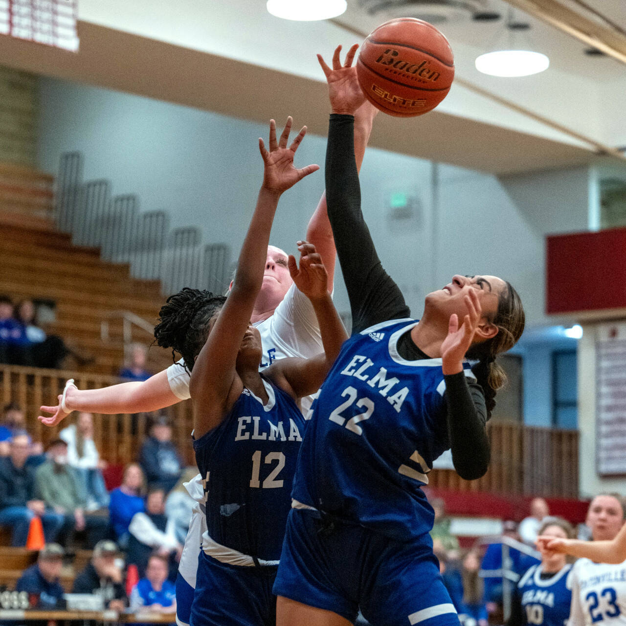 PHOTO BY FOREST WORGUM Elma senior forward Eliza Sibbett (22) and teammate Keke Bol (12) go up for a rebound during the Eagles’ 50-44 loss in a 1A District 4 Tournament game on Saturday at Hoquiam High School.