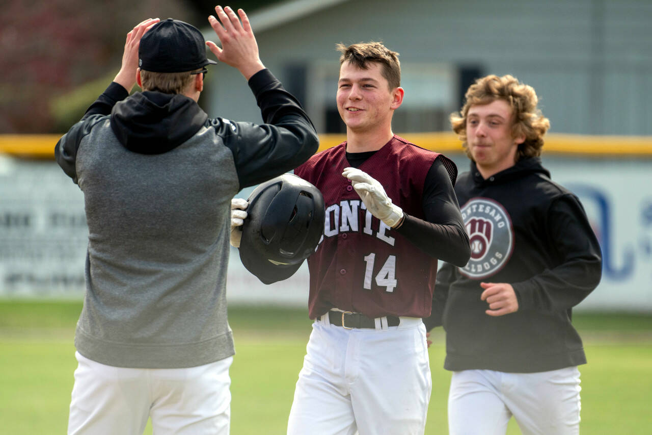 PHOTO BY FOREST WORGUM Montesano’s Colton Grubb (14) celebrates a victory over La Center with teammate Tyce Peterson, left, on Friday in Naches.