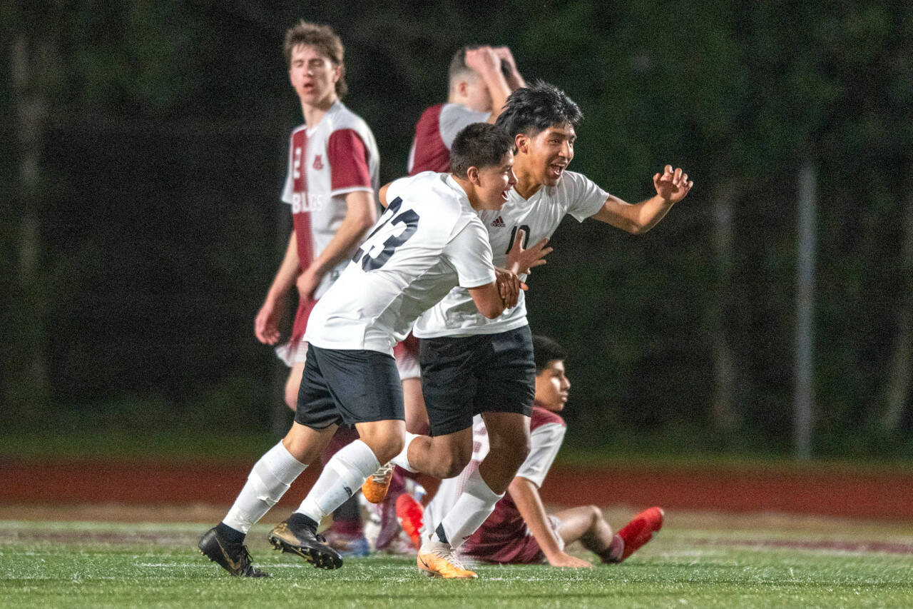 PHOTO BY FOREST WORGUM Raymond South Bend forward Jose Ramirez (right) celebrates after scoring a goal late in the second half against Montesano on Friday at Montesano High School.