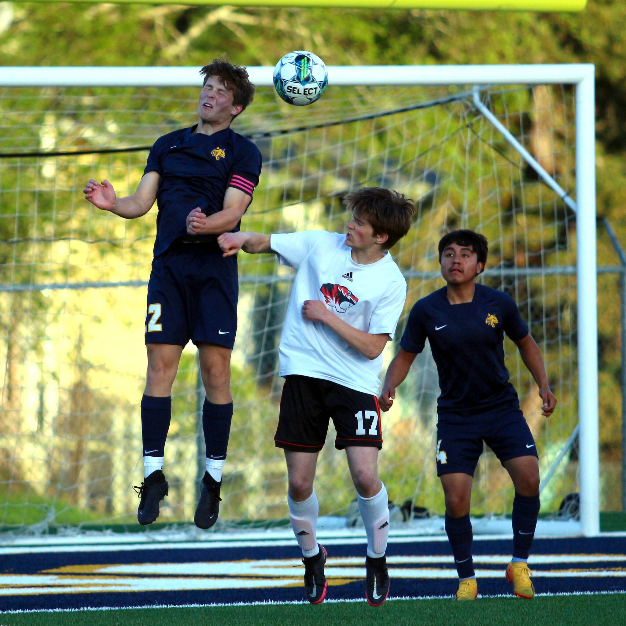 RYAN SPARKS | THE DAILY WORLD Aberdeen co-captain Isaiah Johnson (22) heads the ball against Centralia’s Miles Page as Bobcats defender Angel Espinosa (4) looks on during a game on Monday in Aberdeen.