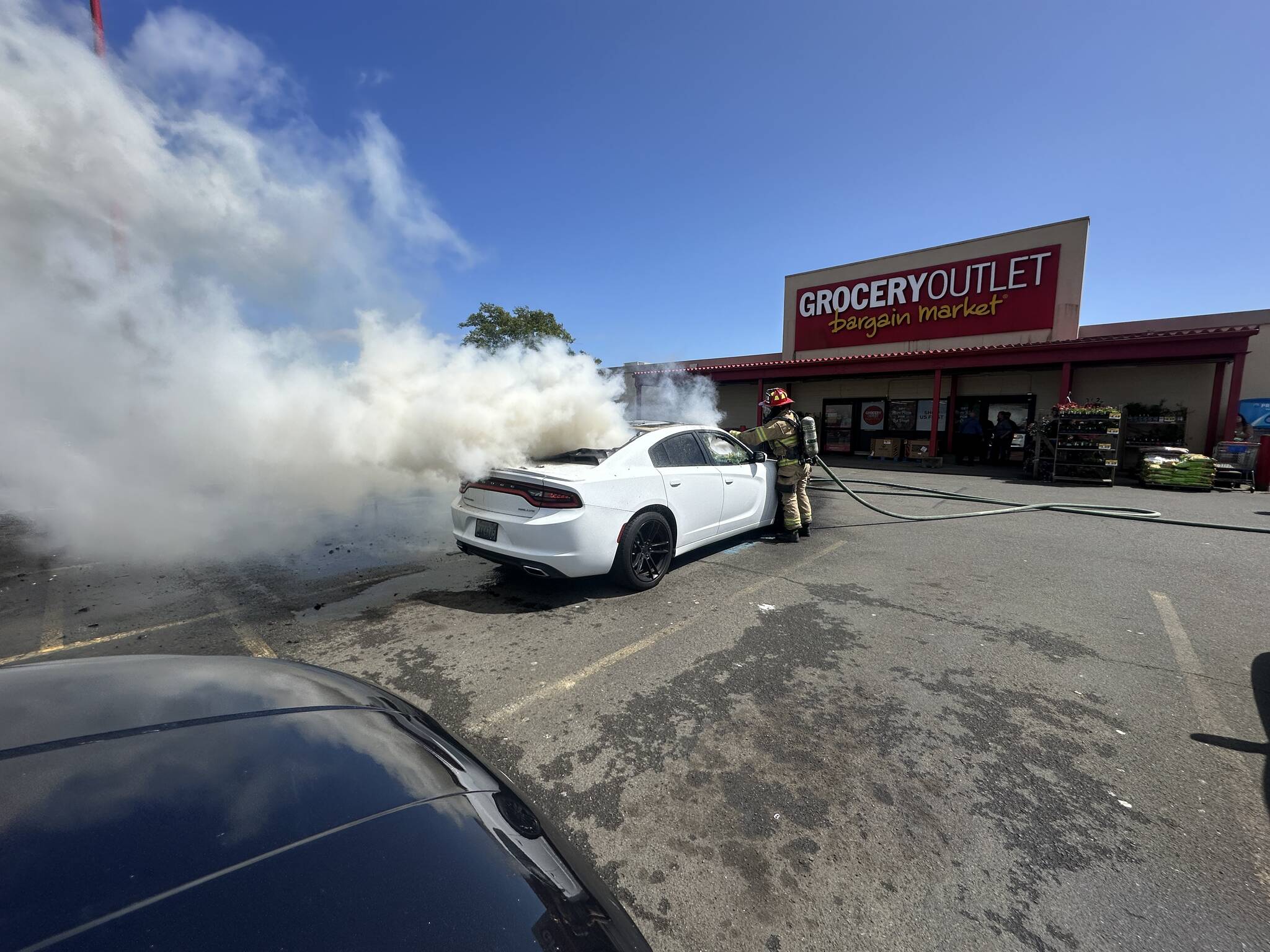 A car was destroyed by fire in a grocery store parking lot in Aberdeen Wednesday. (Courtesy photo / AFD)