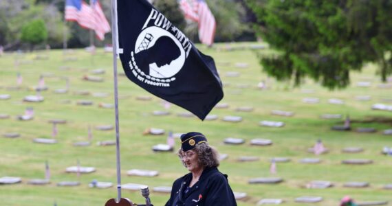 Gwen Tarrance reads the remembrance for prisoners of war during a Memorial Day ceremony at Fern Hill Cemetery on Monday. (Michael S. Lockett / The Daily World)