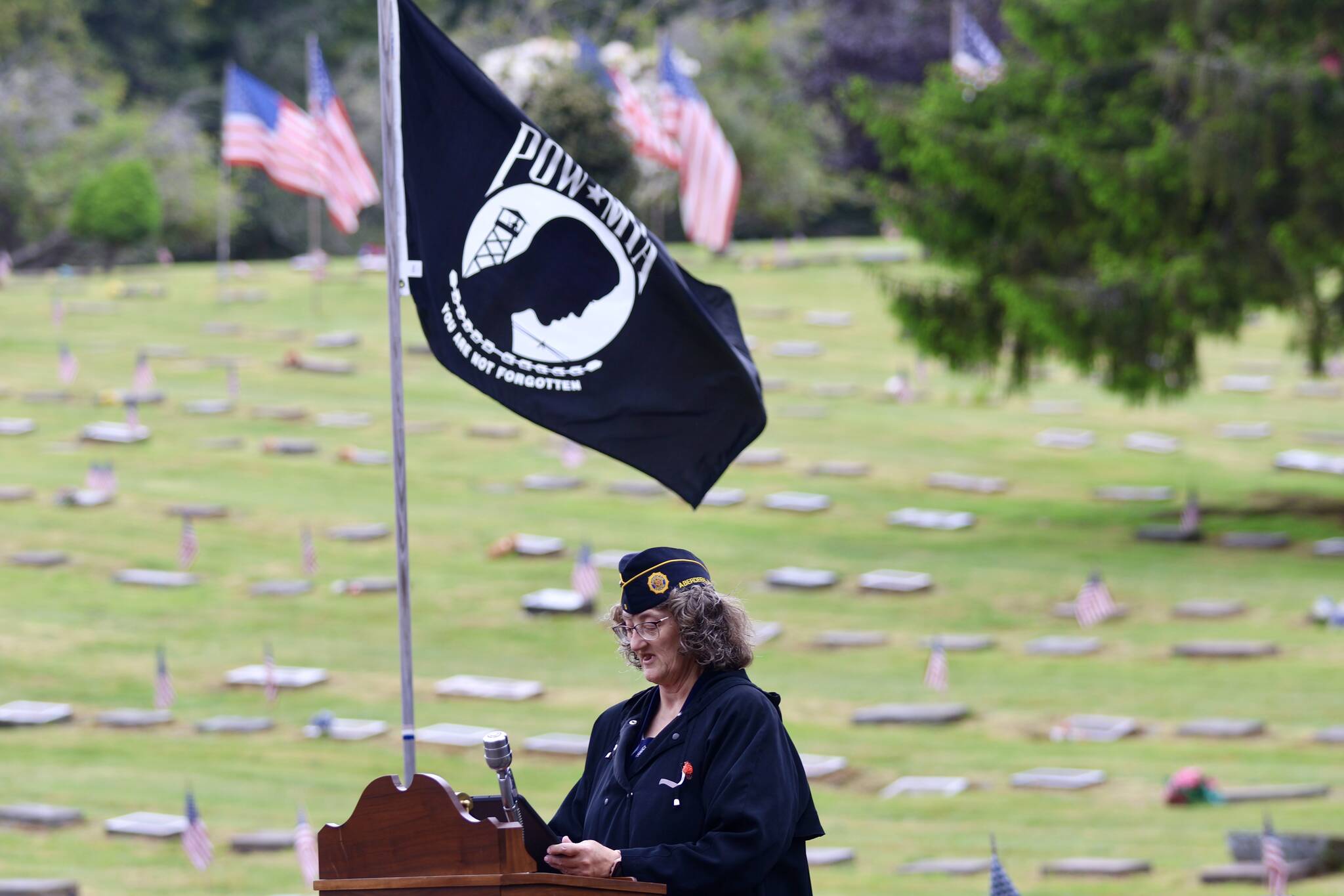 Gwen Tarrance reads the remembrance for prisoners of war during a Memorial Day ceremony at Fern Hill Cemetery on Monday. (Michael S. Lockett / The Daily World)