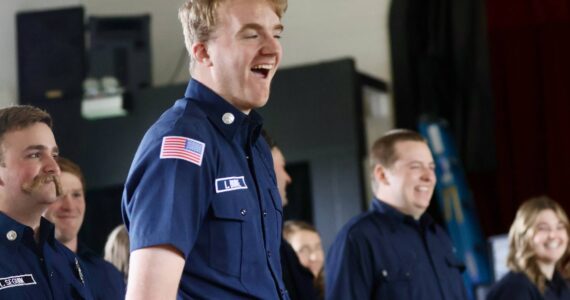 Michael S. Lockett / The Daily World
Members of the county fire academy, with Liam Burke of District 7 in the foreground, celebrate during the graduation ceremony.