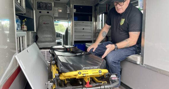 Michael S. Lockett / The Daily World
County Coroner George Kelley points out a feature in the former ambulance the coroner’s office recently purchased.