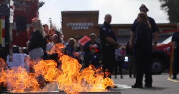 The Aberdeen Fire Department brought out its fire extinguisher use demonstrator during the Badges and Brews event hosted by the Aberdeen Starbucks. (Michael S. Lockett / The Daily World)