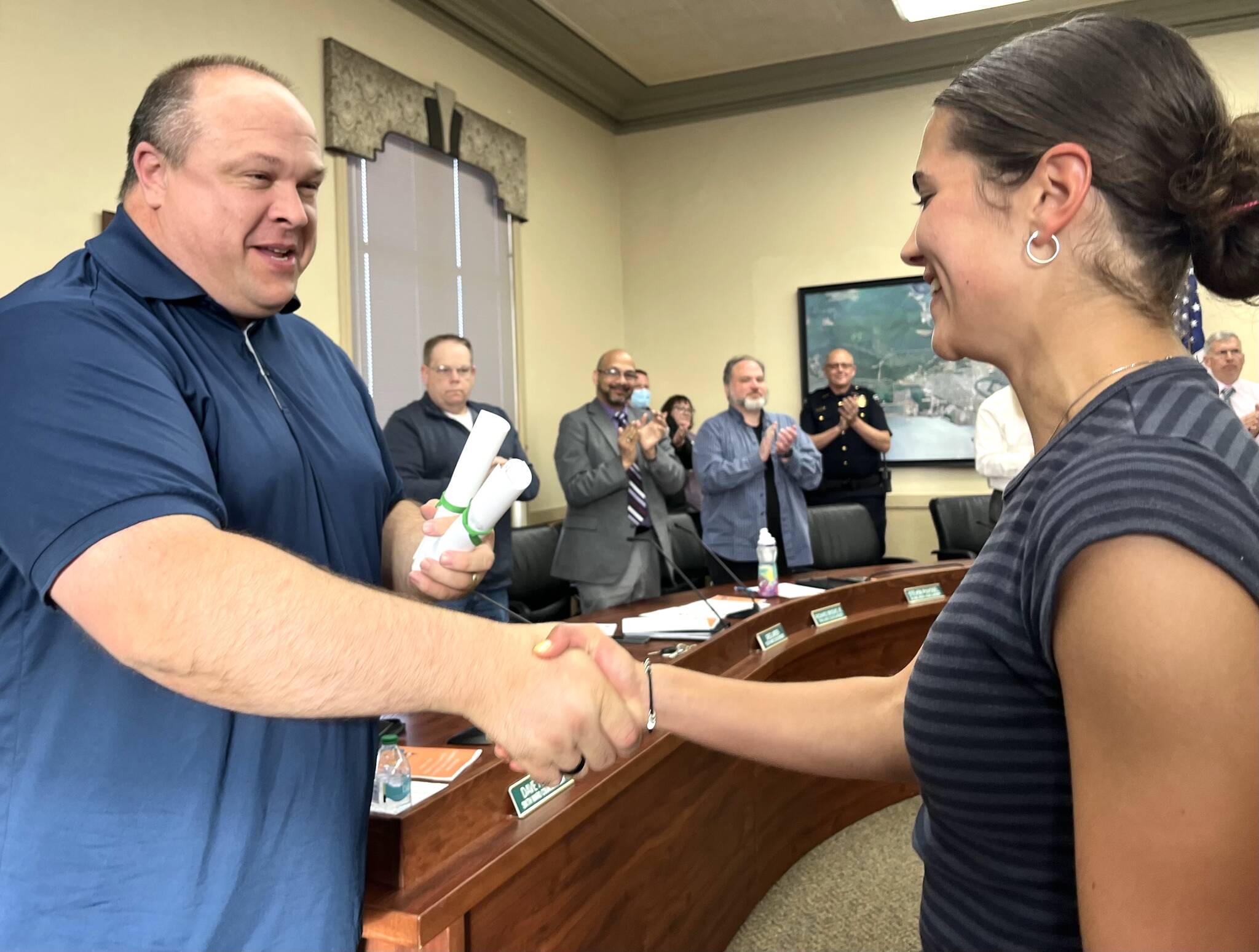 Hoquiam Mayor Ben Winkelman, left, congratulates Jane Roloff, a Hoquiam High School senior, for her exceptionally long list of athletic accolades through not only the 2023-24 school year, but her whole career as a Hoquiam Grizzly. Roloff will start attending the University of Portland this fall. "Jane Roloff's continued success and improvements also bring immense pride to the community, where it had been nearly 30 years since we last held an individual cross country state title," Winkelman read as part of his proclamation that thoroughly recognized Roloff's almost endless list of accolades. (Matthew N. Wells / The Daily World)