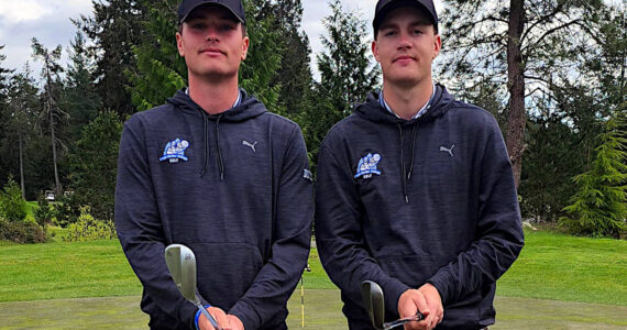 SUBMITTED PHOTO 
Grays Harbor College golfers Cole (left) and Brett Wasson pose for a photo during a NWAC League Match in April at Port Orchard. The college decided to suspend the men’s golf and men’s wrestling programs on Monday.
