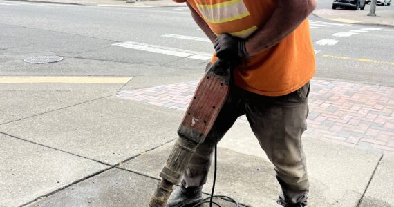 Matthew N. Wells / The Daily World
Jeff Stevens, lead carpenter for the city of Aberdeen, busts up pavement on a small patch of sidewalk that will host Darrell Westmoreland’s star. The music photographer is the 92nd Aberdeen Walk of Fame star recipient.