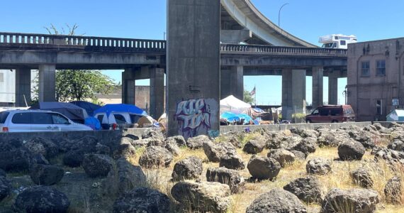 Matthew N. Wells / The Daily World
On a scorcher of a day — the National Weather Service set a heat advisory Monday through Tuesday at 11 a.m., — people at the homeless encampment just off State Street were seen covering their heads from the hot sun.