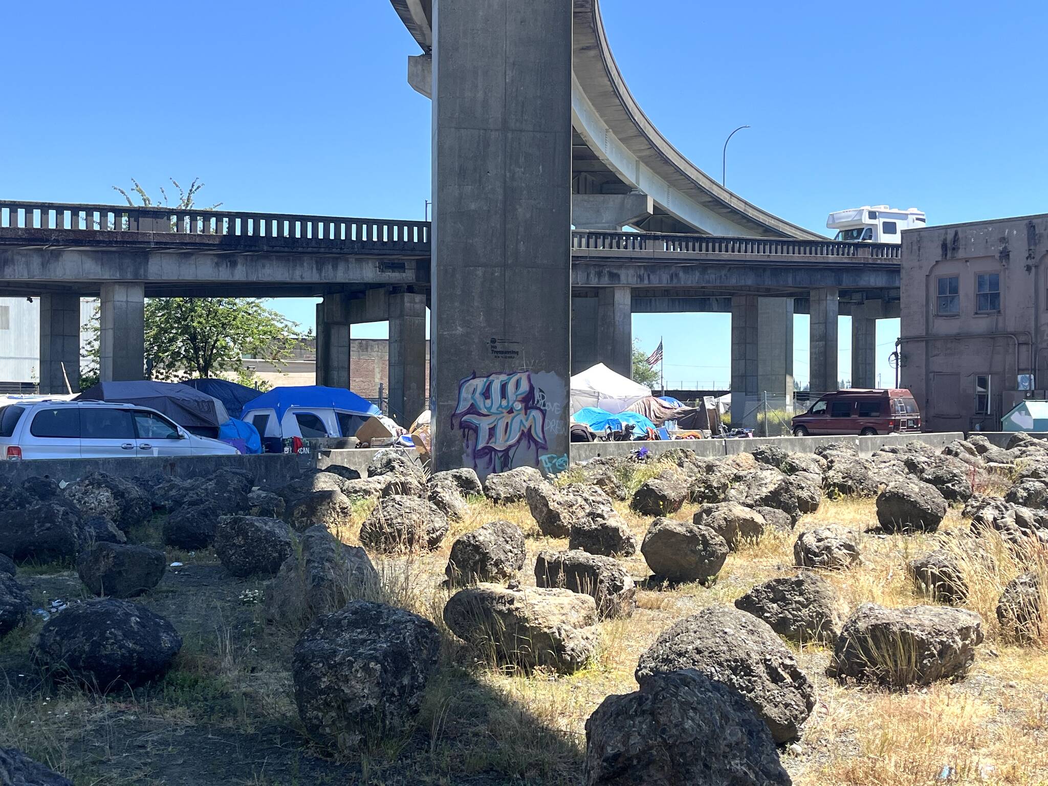 Matthew N. Wells / The Daily World
On a scorcher of a day — the National Weather Service set a heat advisory Monday through Tuesday at 11 a.m., — people at the homeless encampment just off State Street were seen covering their heads from the hot sun.