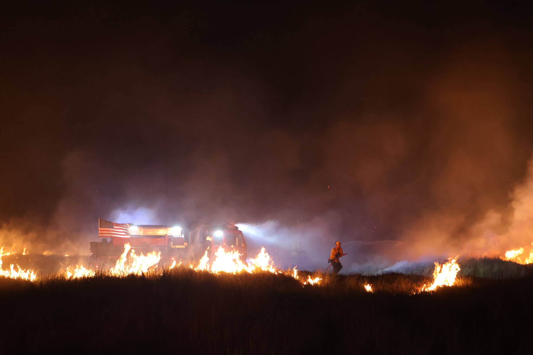 Ocean Shores firefighters respond to a dune grass fire on the 4th of July. (Michael S. Lockett / The Daily World)