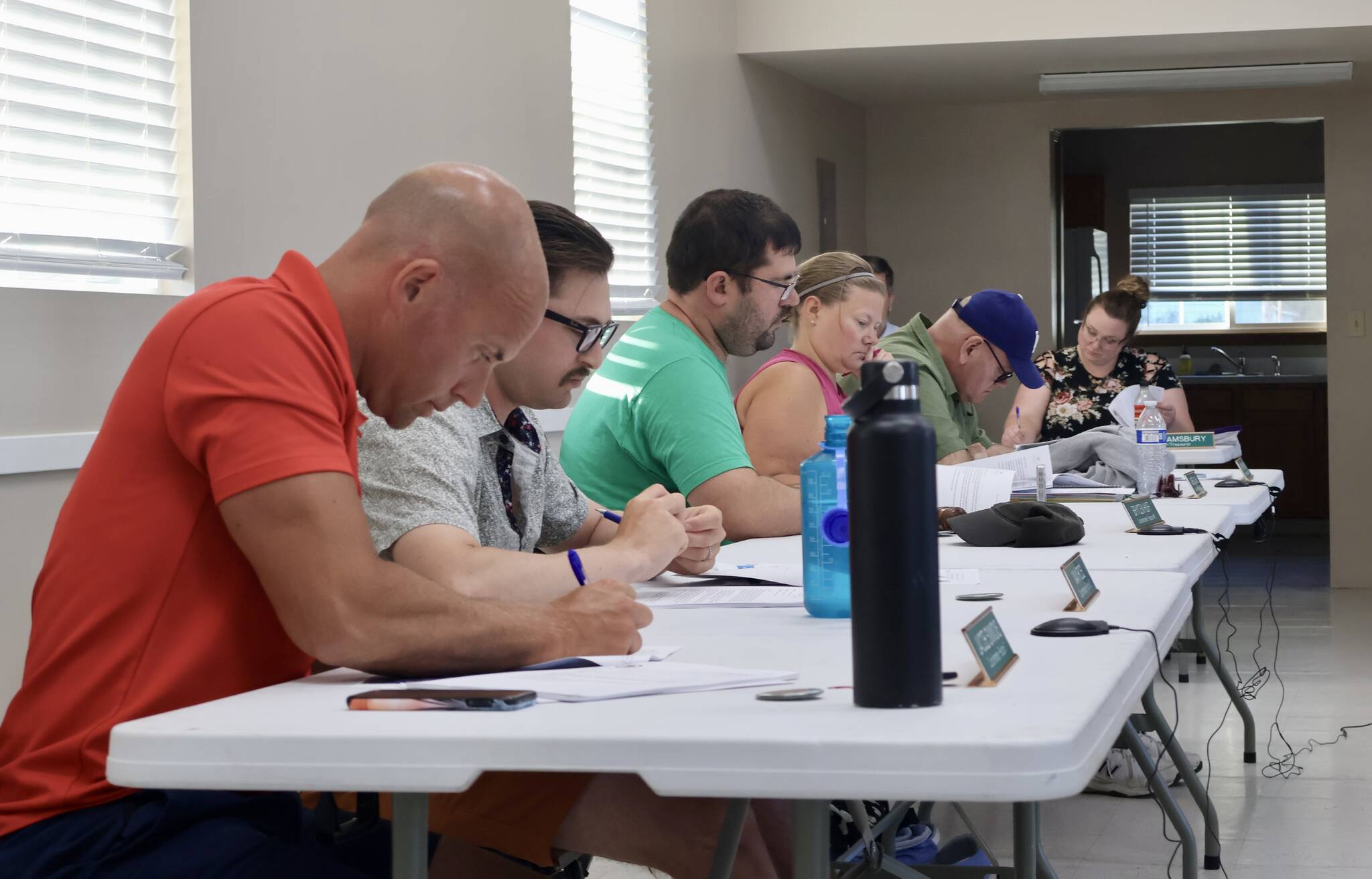 McCleary City Council members read a proposal during a meeting on July 10. (Michael S. Lockett / The Daily World)