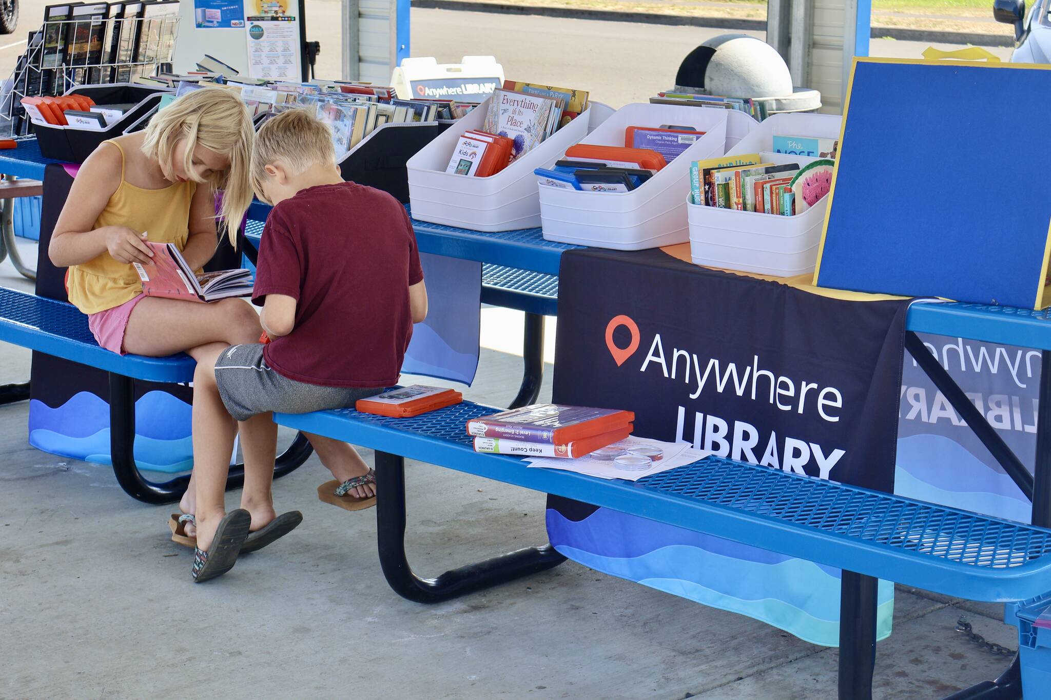 Kids read books during an Anywhere Library visit to Cosmopolis, the first stop as the program stands up in the county. (Michael S. Lockett / The Daily World)